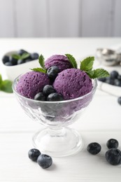 Photo of Tasty sorbet with blueberries and mint in dessert bowl on white wooden table against grey background, closeup