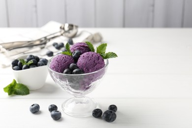 Photo of Tasty sorbet with blueberries and mint in dessert bowl on white wooden table against grey background, closeup. Space for text