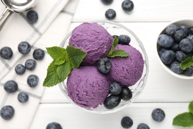 Photo of Tasty sorbet with blueberries and mint in dessert bowl on white wooden table, flat lay