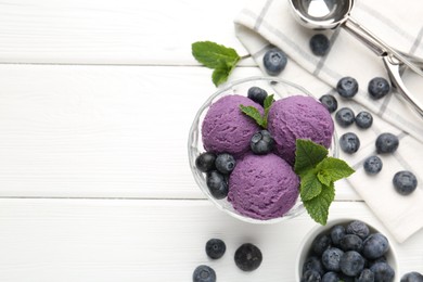 Photo of Tasty sorbet with blueberries and mint in dessert bowl on white wooden table, flat lay. Space for text
