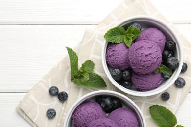 Photo of Tasty sorbet with blueberries and mint in bowls on white wooden table, top view