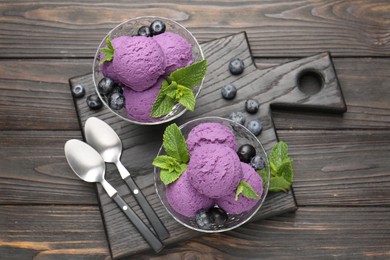 Photo of Tasty sorbet with blueberries and mint in dessert bowls on wooden table, top view