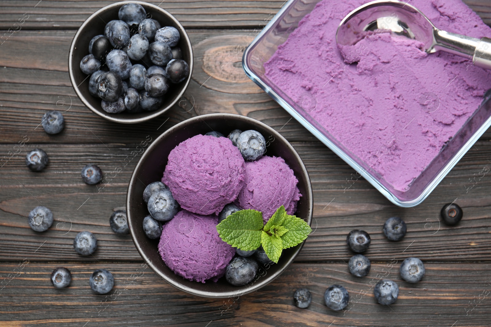Photo of Tasty sorbet with blueberries and mint on wooden table, flat lay