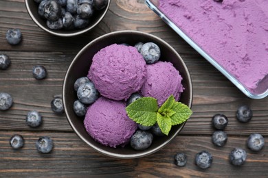 Photo of Tasty sorbet with blueberries and mint on wooden table, flat lay