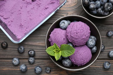 Photo of Tasty sorbet with blueberries and mint on wooden table, flat lay
