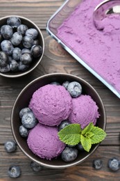 Photo of Tasty sorbet with blueberries and mint on wooden table, flat lay