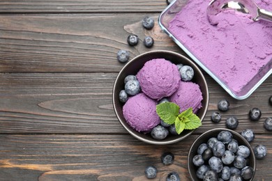 Photo of Tasty sorbet with blueberries and mint on wooden table, flat lay. Space for text