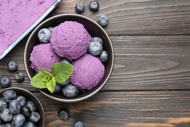 Photo of Tasty sorbet with blueberries and mint on wooden table, flat lay. Space for text