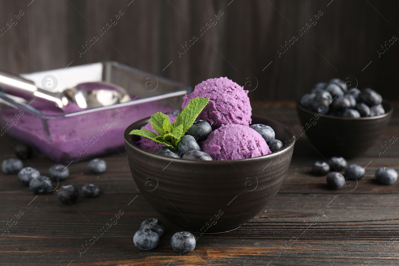 Tasty sorbet with blueberries and mint in bowl on wooden table, closeup Photo of Tasty sorbet with blueberries and mint in bowl on wooden table, closeup