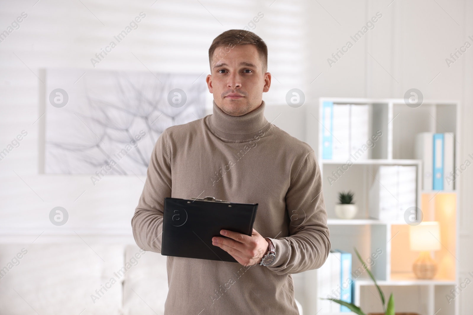 Photo of Portrait of psychologist with clipboard in office