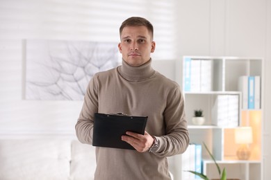 Photo of Portrait of psychologist with clipboard in office
