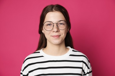 Photo of Teenage girl in glasses on crimson background