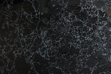 Photo of Texture of black marble surface as background, top view