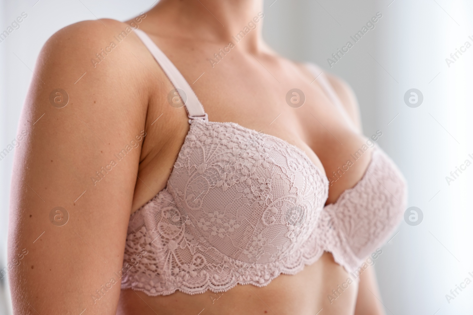 Woman wearing beautiful bra at home, closeup Photo of Woman wearing beautiful bra at home, closeup