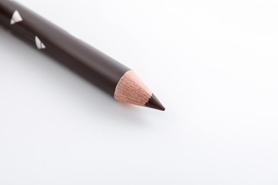 Photo of One brown eyebrow pencil on white background, closeup. Space for text
