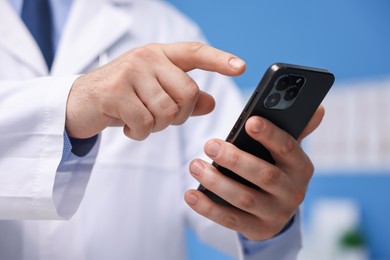 Photo of Doctor with smartphone in clinic, closeup. Online medical consultation