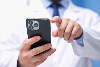 Photo of Doctor with smartphone in clinic, closeup. Online medical consultation