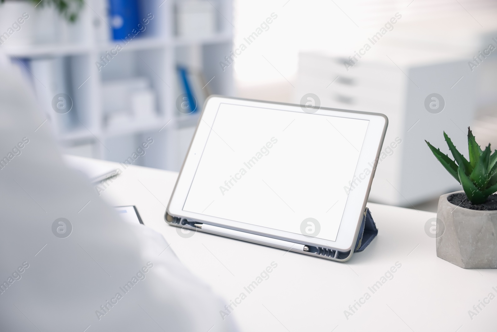 Doctor having online consultation via tablet in clinic, closeup Photo of Doctor having online consultation via tablet in clinic, closeup