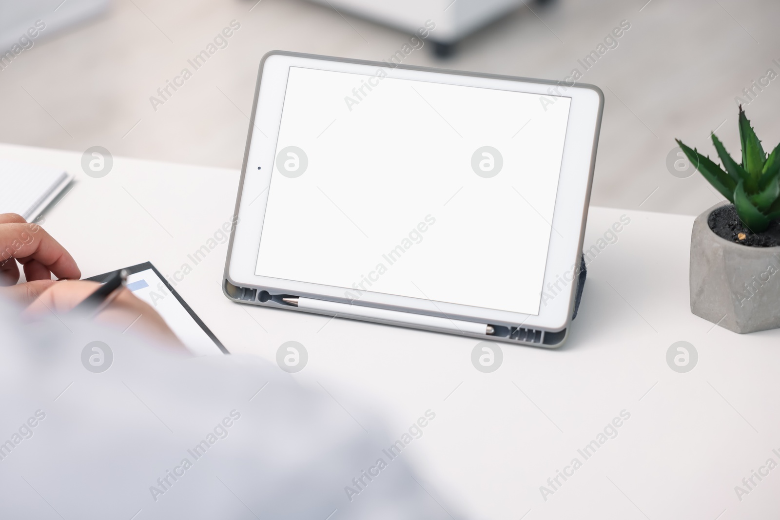 Doctor having online consultation via tablet in clinic, closeup Photo of Doctor having online consultation via tablet in clinic, closeup