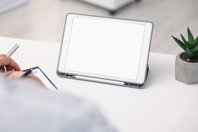 Photo of Doctor having online consultation via tablet in clinic, closeup