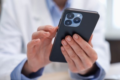Photo of Doctor with smartphone in clinic, closeup. Online medical consultation
