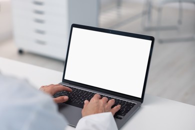 Photo of Doctor using laptop in clinic, closeup. Online medical consultation