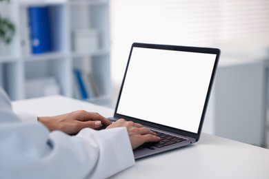 Photo of Doctor using laptop in clinic, closeup. Online medical consultation