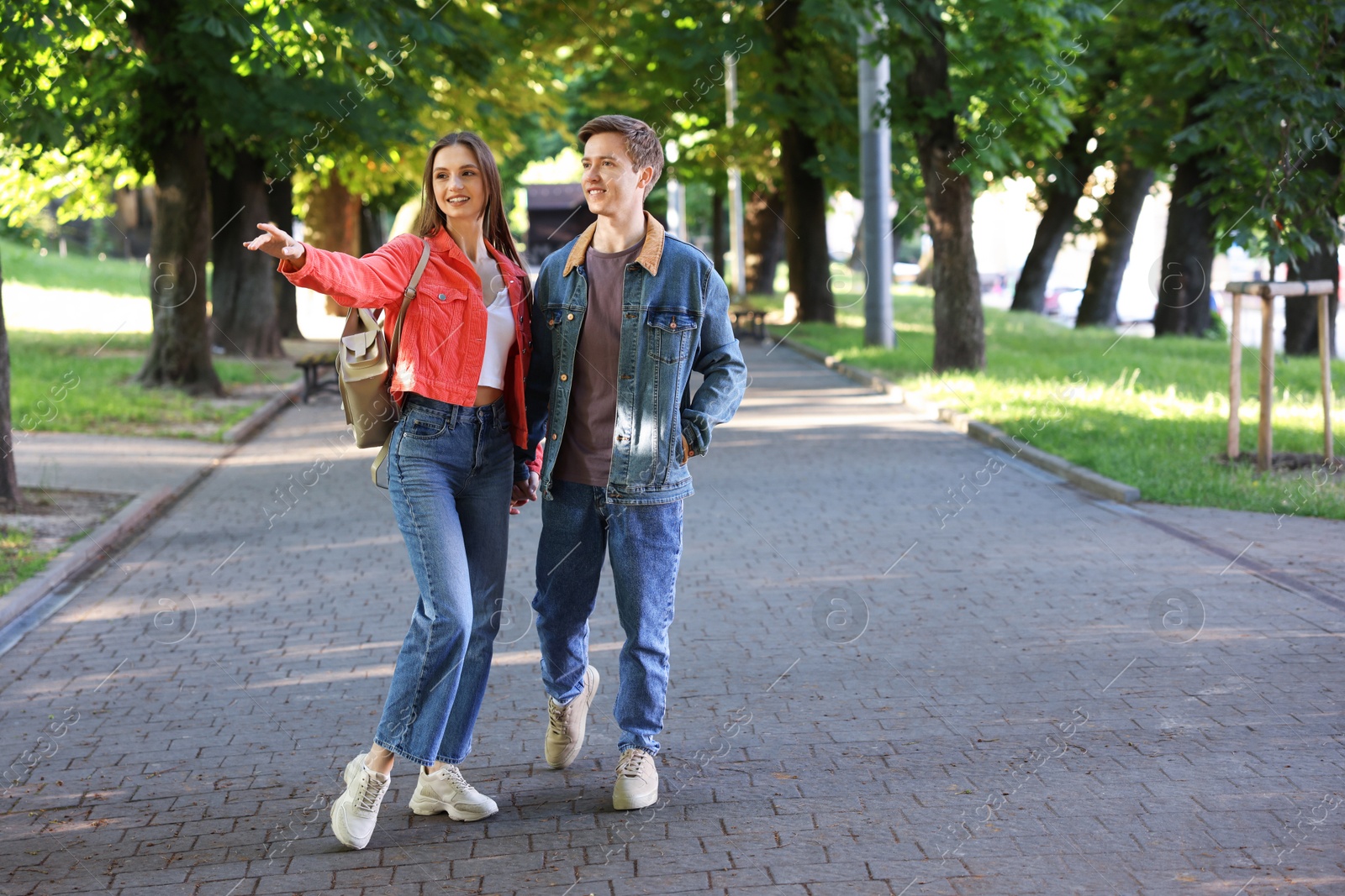 Lovely couple walking together in park, space for text Photo of Lovely couple walking together in park, space for text