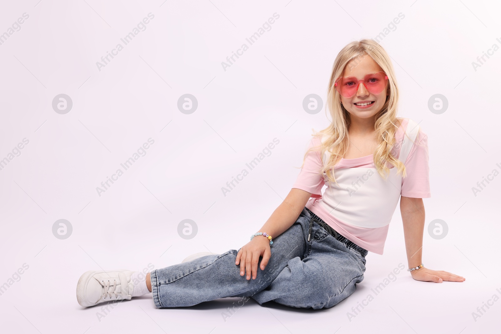 Little girl on white background in photo studio. Space for text Photo of Little girl on white background in photo studio. Space for text