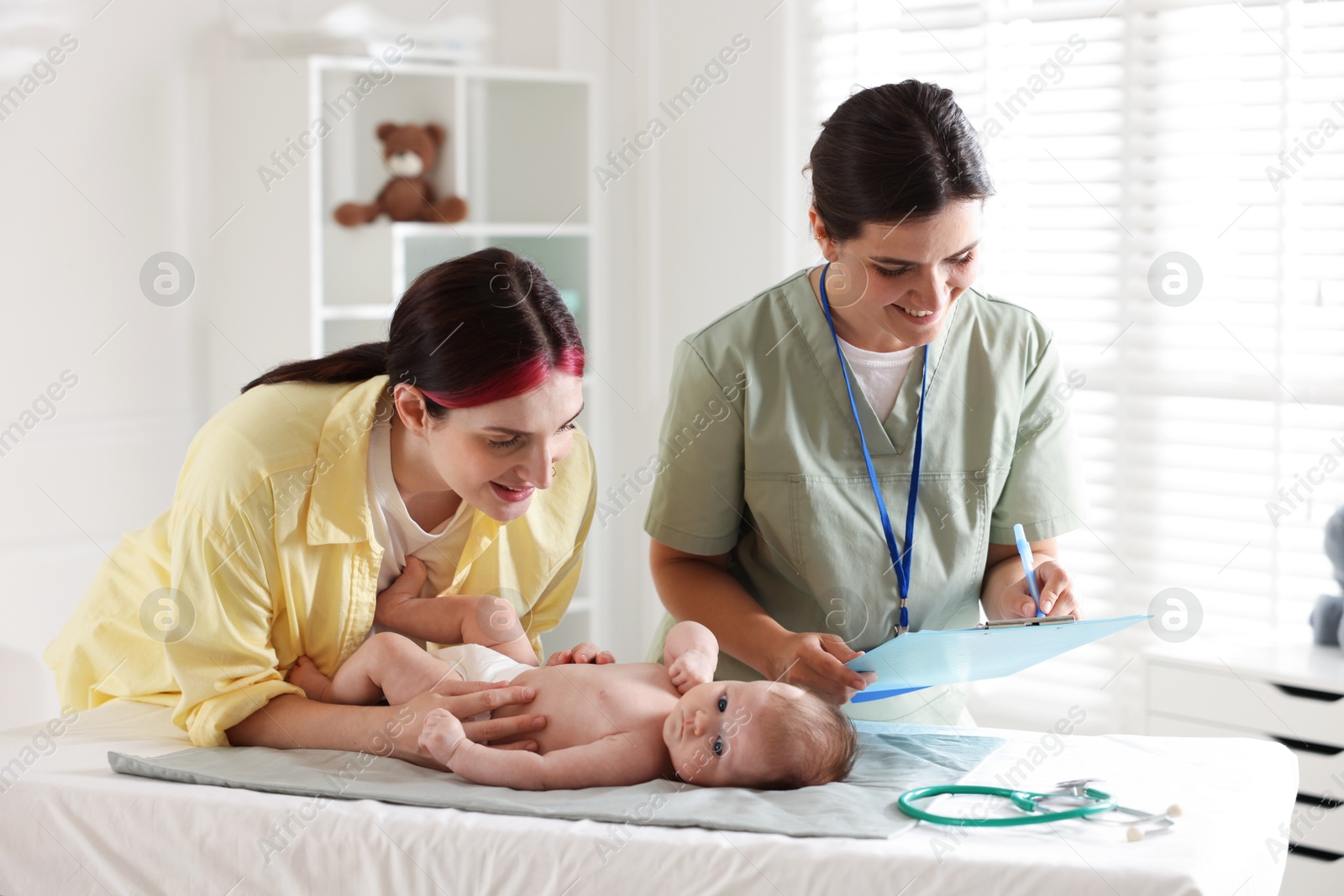 Photo of Mother and her cute baby having appointment with pediatrician in hospital