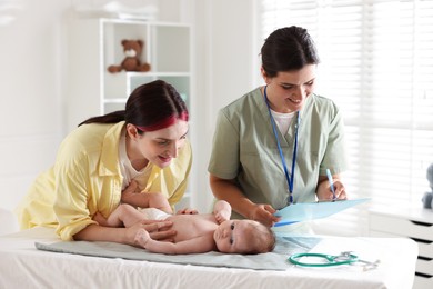 Photo of Mother and her cute baby having appointment with pediatrician in hospital