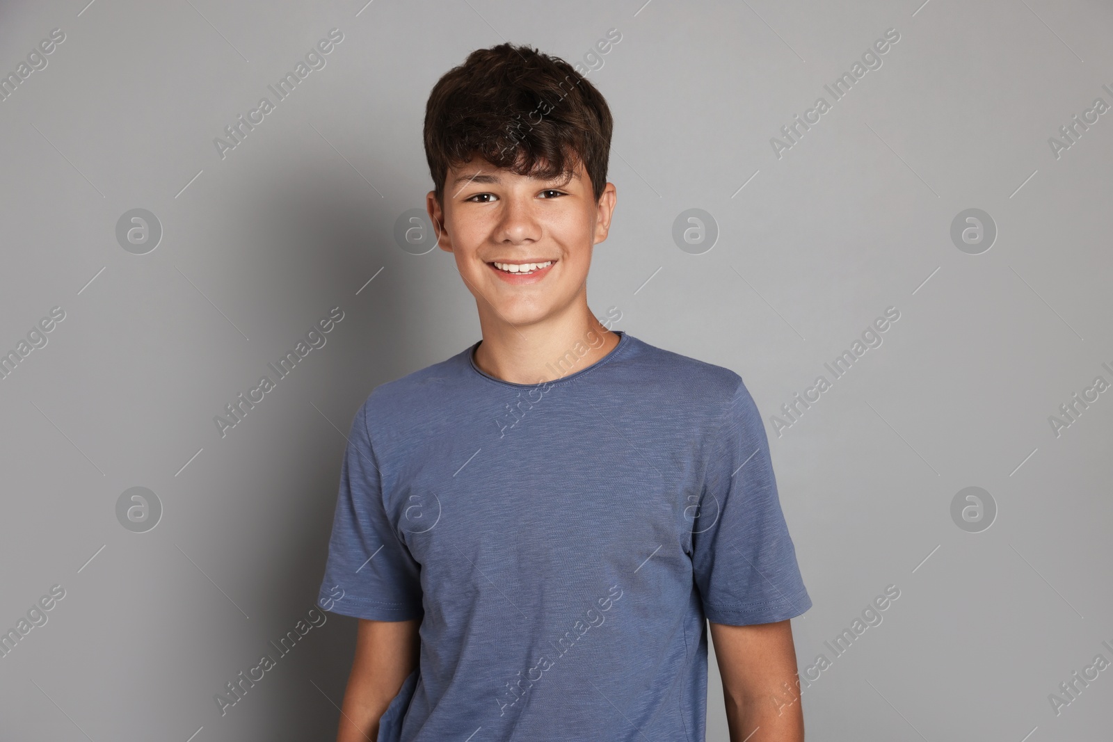 Portrait of teenage boy on grey background Photo of Portrait of teenage boy on grey background