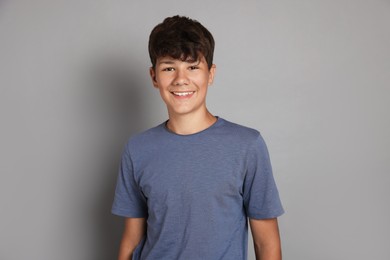 Photo of Portrait of teenage boy on grey background