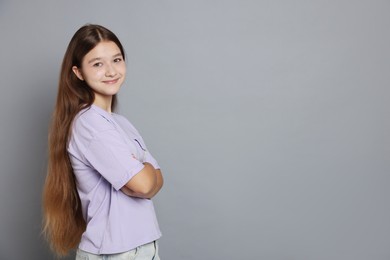 Photo of Portrait of teenage girl on grey background, space for text