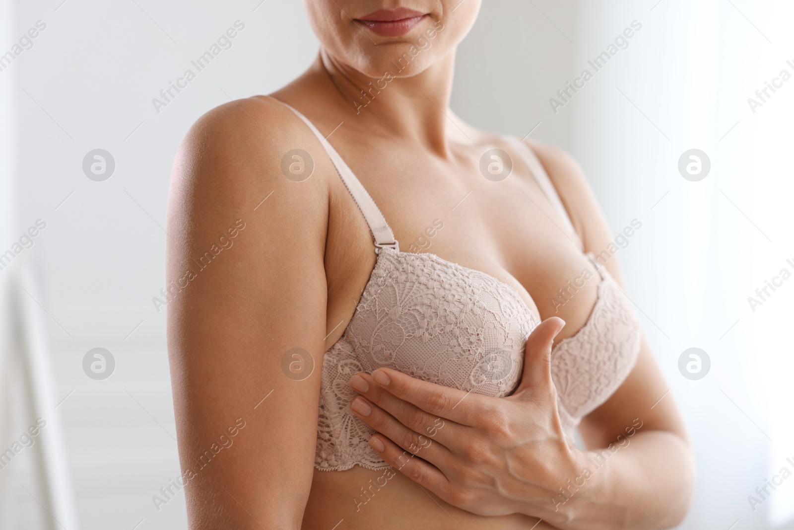Woman wearing beautiful bra at home, closeup Photo of Woman wearing beautiful bra at home, closeup