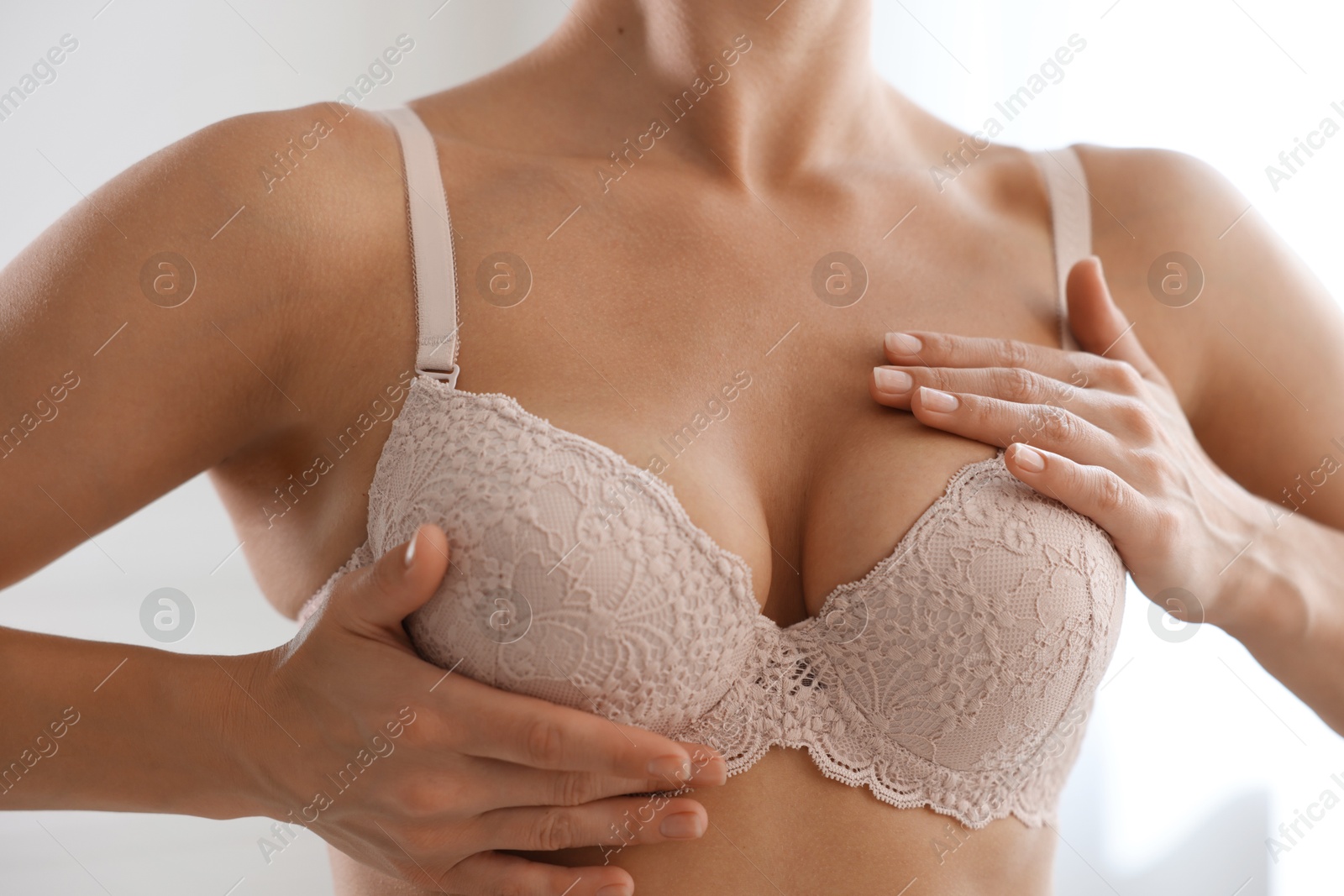Woman wearing beautiful bra at home, closeup Photo of Woman wearing beautiful bra at home, closeup