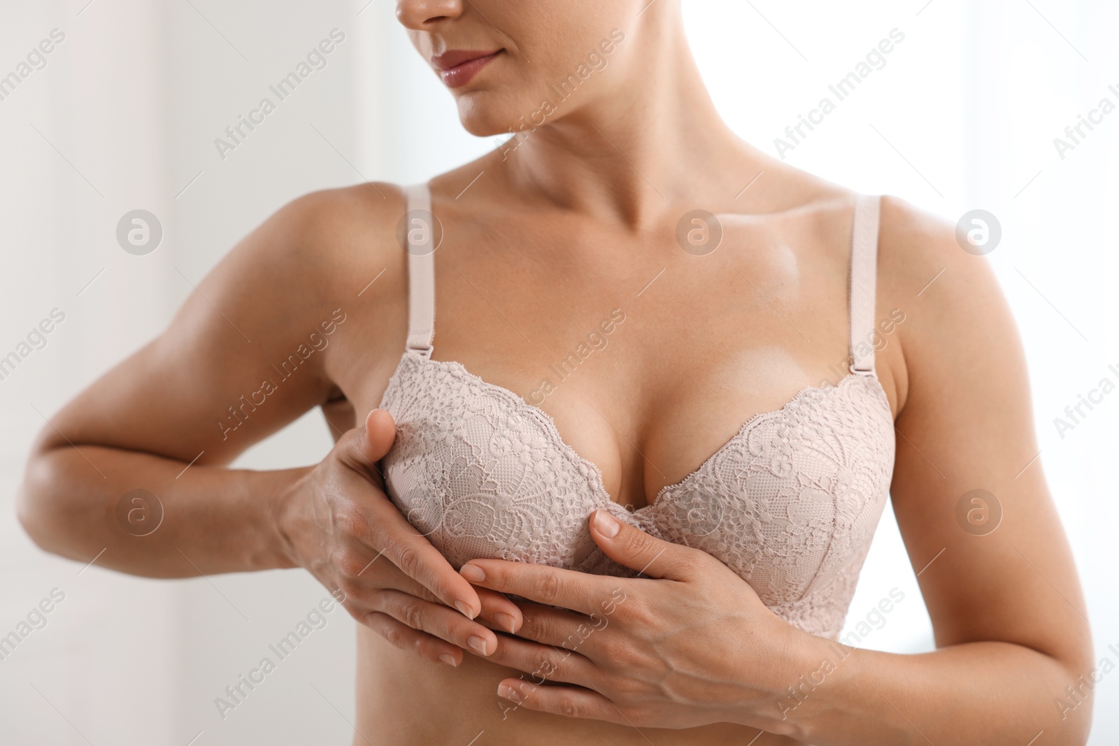 Woman wearing beautiful bra at home, closeup Photo of Woman wearing beautiful bra at home, closeup