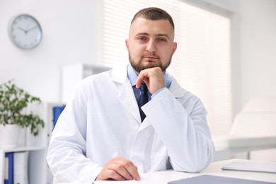 Photo of Portrait of doctor in uniform at table indoors
