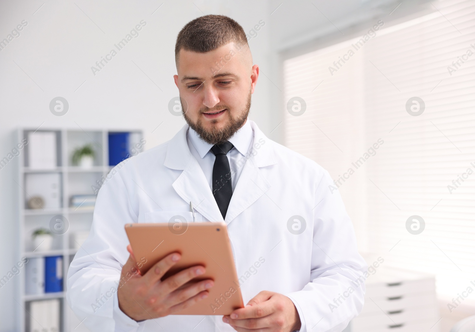 Doctor with tablet in clinic. Online medical consultation Photo of Doctor with tablet in clinic. Online medical consultation