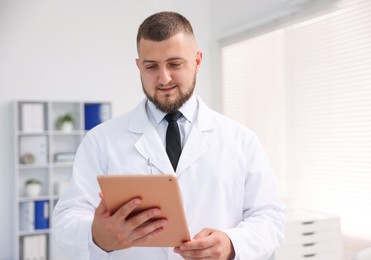 Photo of Doctor with tablet in clinic. Online medical consultation