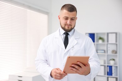 Photo of Doctor with tablet in clinic. Online medical consultation