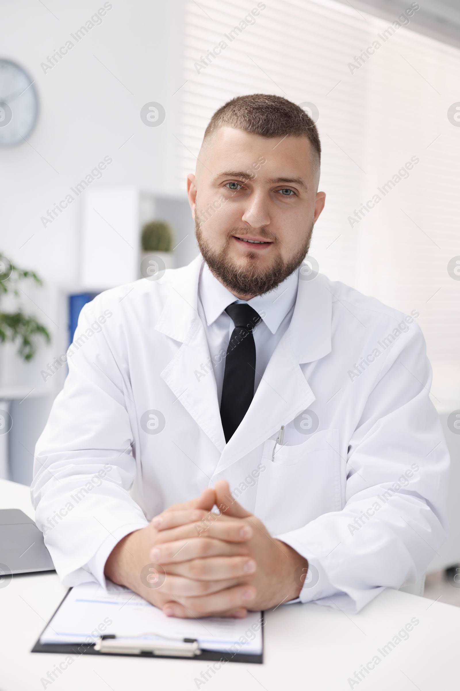 Portrait of doctor in uniform at table indoors Photo of Portrait of doctor in uniform at table indoors