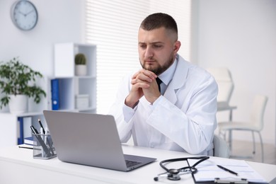 Photo of Doctor having online consultation via laptop in clinic