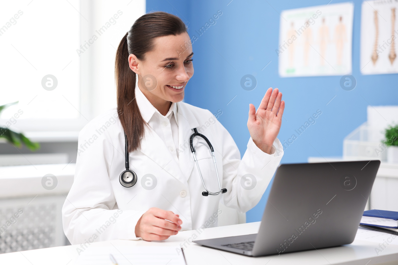 Photo of Doctor having online consultation via laptop in clinic