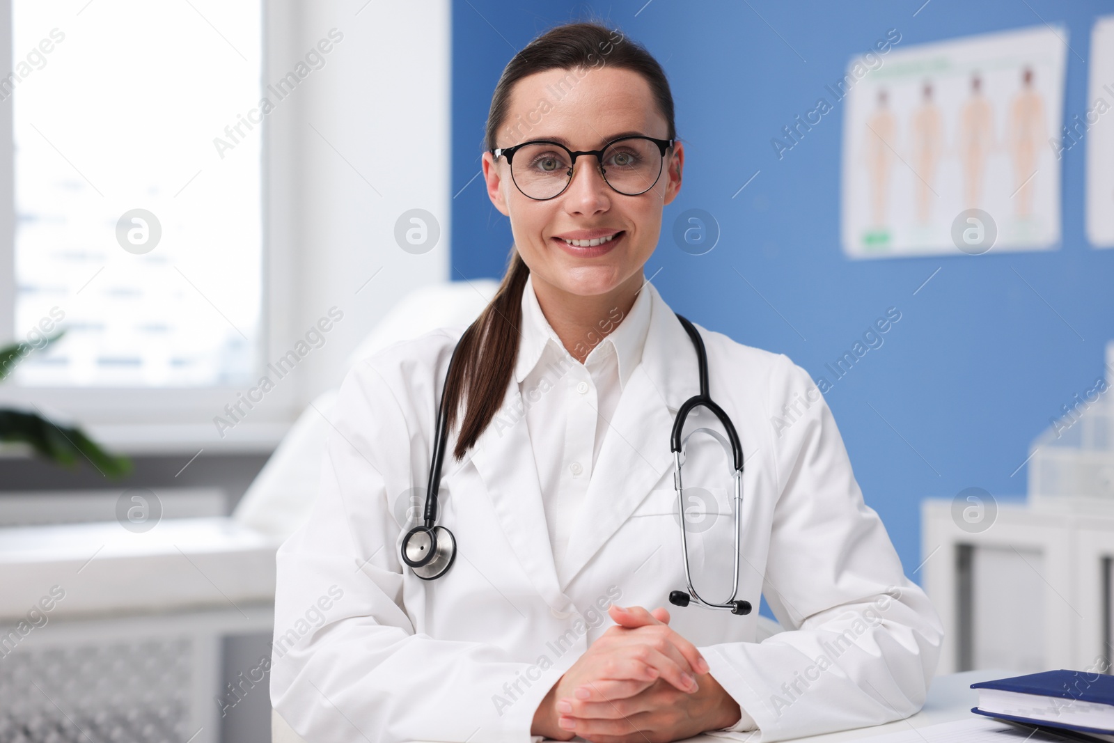 Portrait of happy doctor in glasses indoors Photo of Portrait of happy doctor in glasses indoors