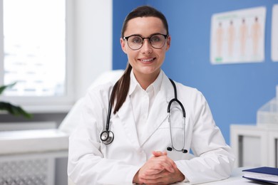 Photo of Portrait of happy doctor in glasses indoors