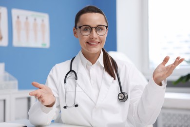 Photo of Portrait of happy doctor in glasses indoors