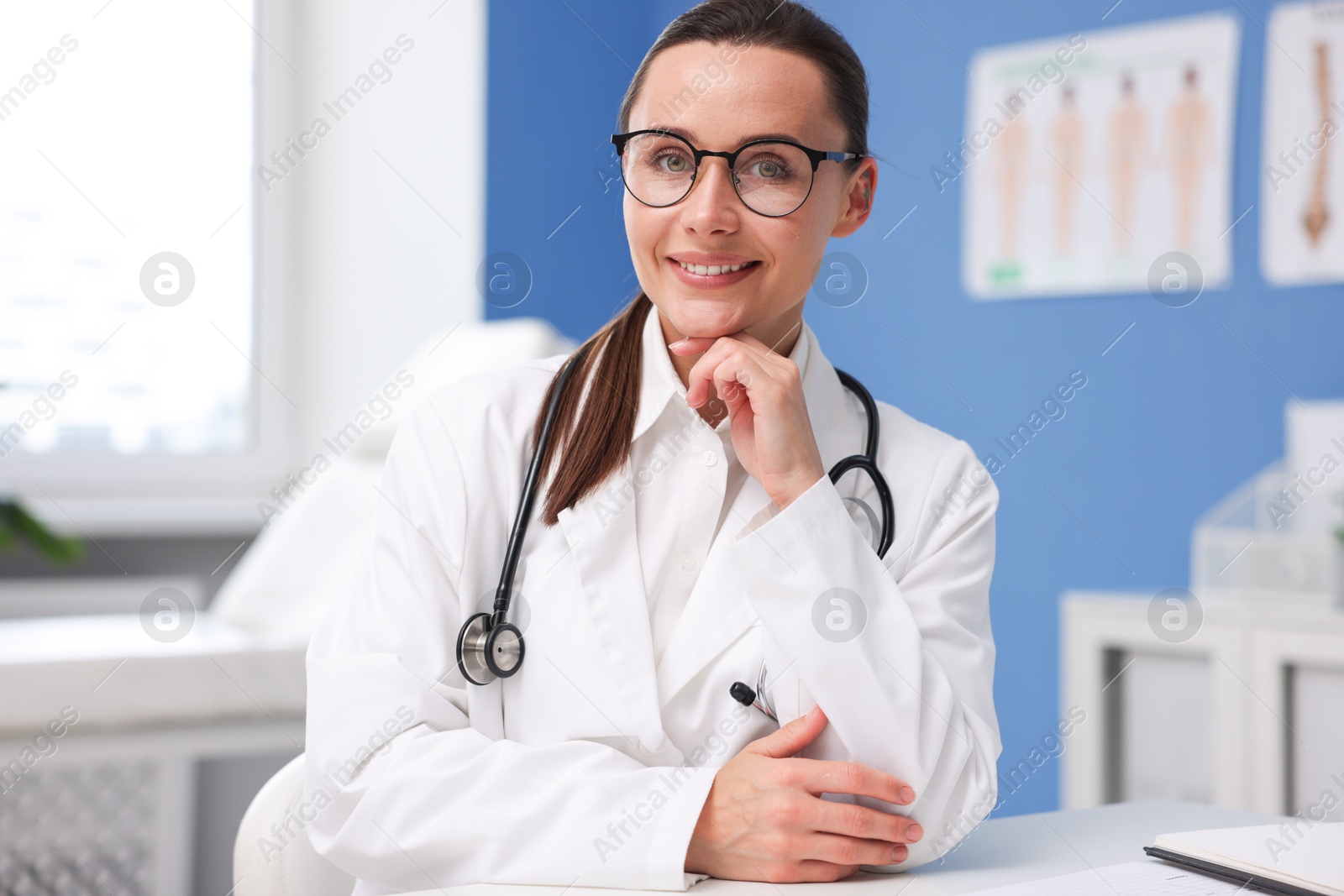 Portrait of happy doctor in glasses indoors Photo of Portrait of happy doctor in glasses indoors
