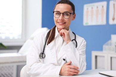 Photo of Portrait of happy doctor in glasses indoors