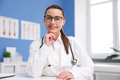 Photo of Portrait of happy doctor in glasses indoors